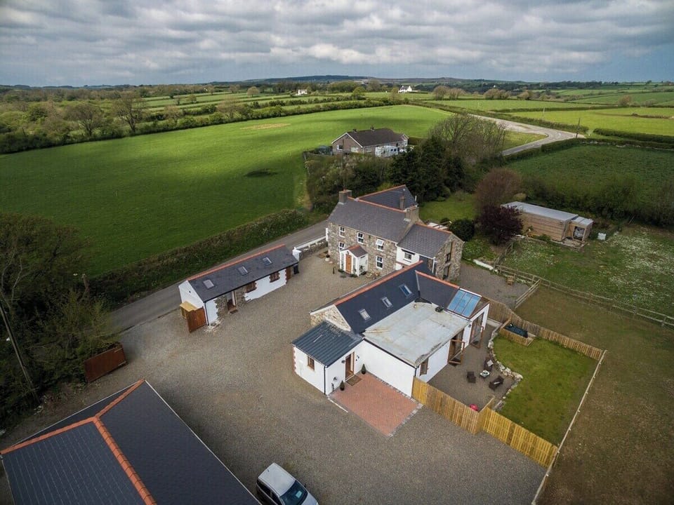 Aerial view of farmhouse, barn and studio