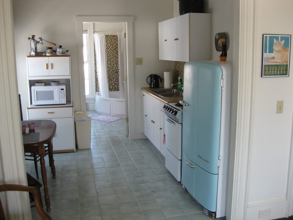 Small, efficient kitchen (who's cooking!), and 1941 Kelvinator..