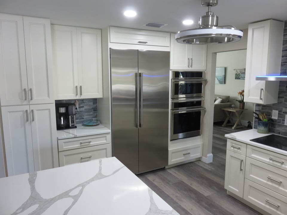 Stainless steel appliances, dual convection ovens and quartz countertops.