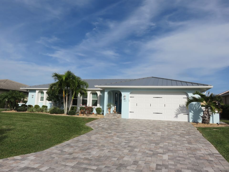 Our piece of paradise with brick paver driveway.