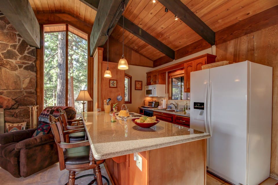 Galley-type kitchen with granite countertops. 

