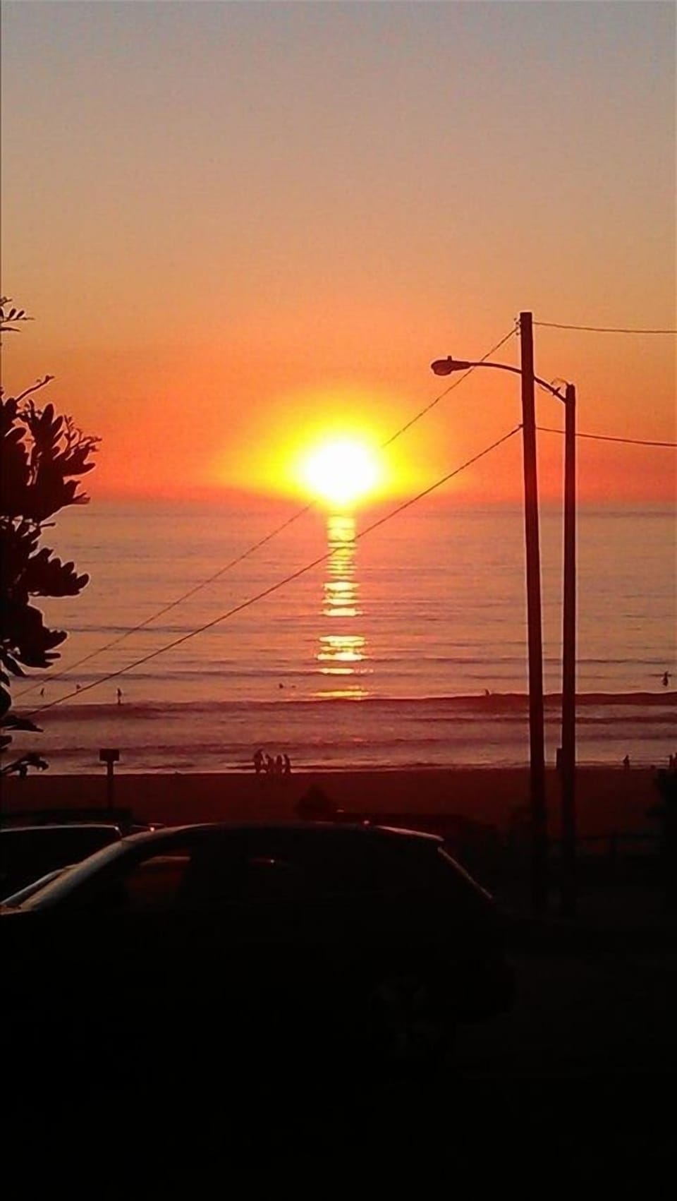 The perfect sunset as seen from the Strand..three doors from our beach house