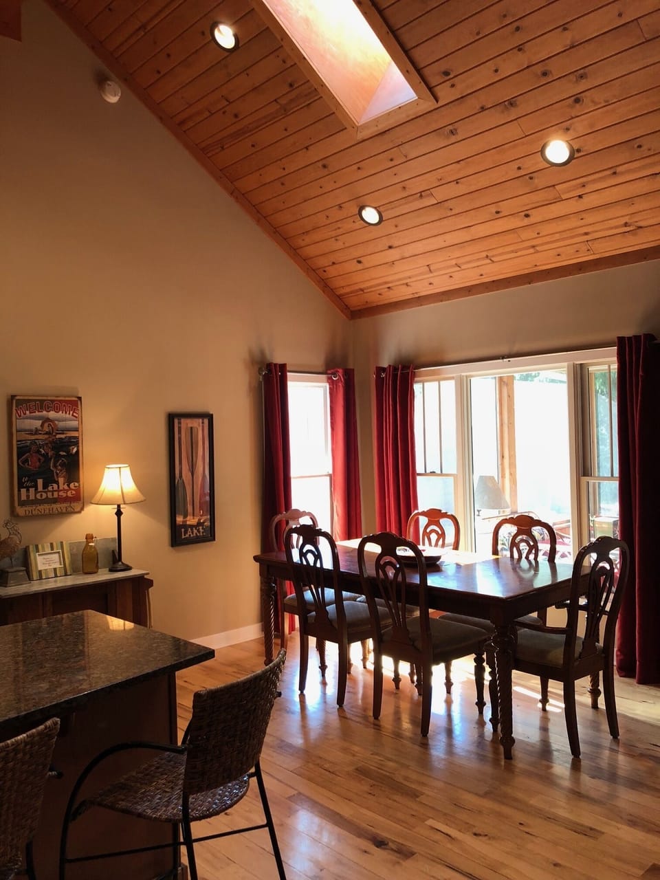 The light-filled great room has a dining area, fireplace, kitchen & living room