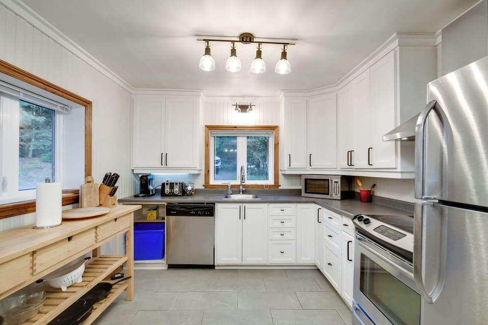 Recently renovated kitchen stainless steel applications and new large tile floor