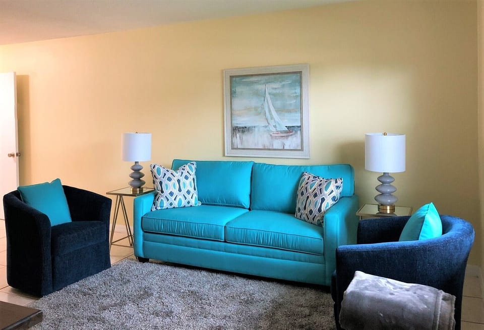 New furniture in bright beach colors create a comfortable and relaxing room.