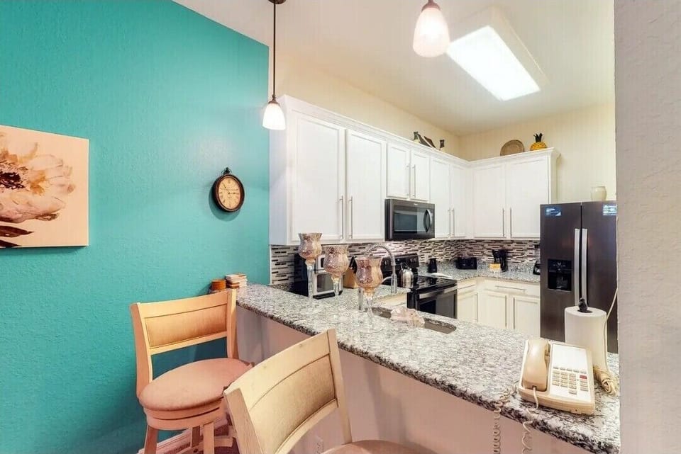 Granite counters and swivel bar stools for added comfort!
