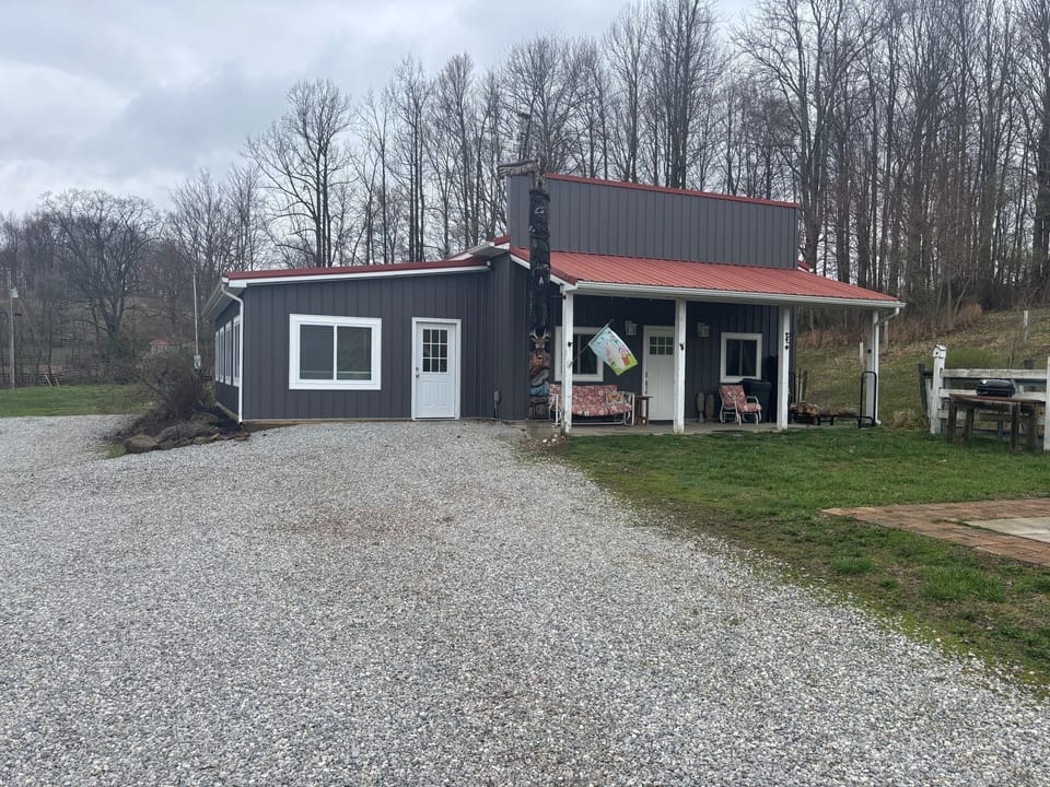 New siding, an enclosed porch and you can almost see the fire pit on the side.