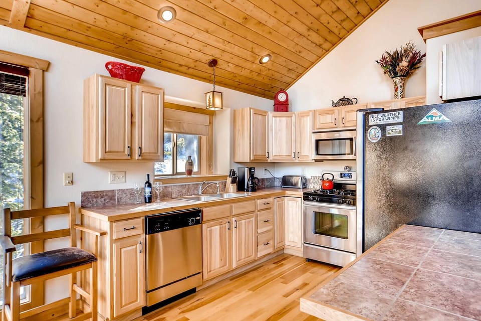 The kitchen has custom wood cabinetry and tile granite counter tops. The appliances are new stainless.