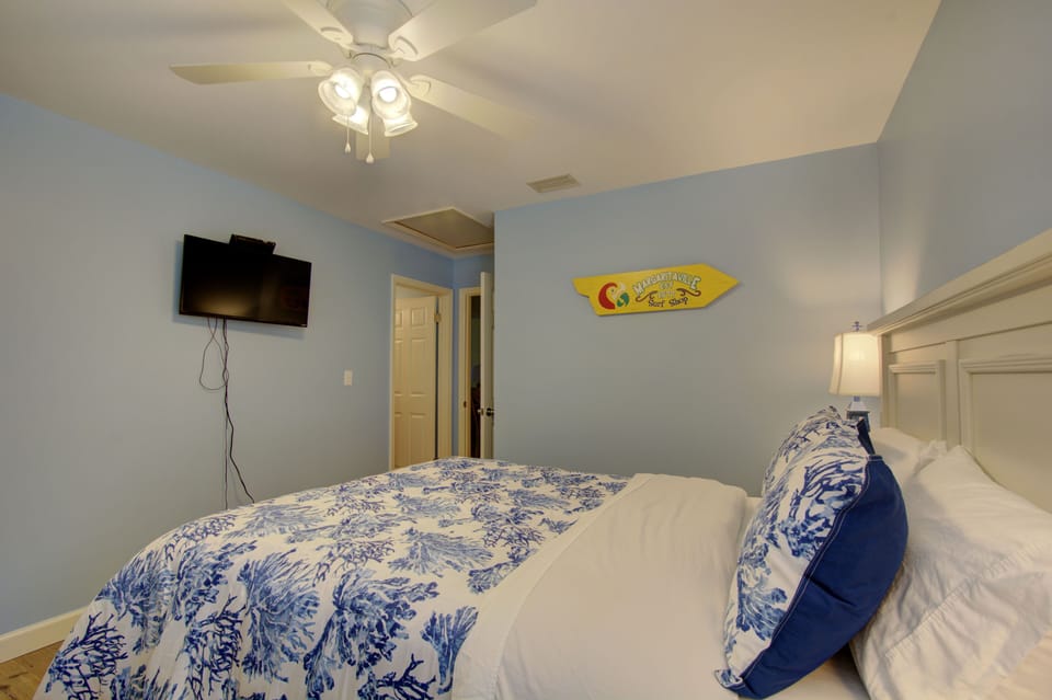 Queen Bedroom With TV - The guest bedroom includes a wall-mounted TV and dresser, giving the condo two true bedrooms.