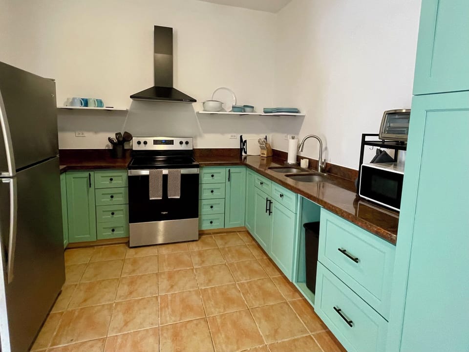 Newly refreshed kitchen with full size refrigerator & electric range.