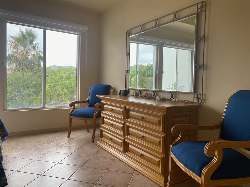 Spacious dresser and large mirror in master bedroom