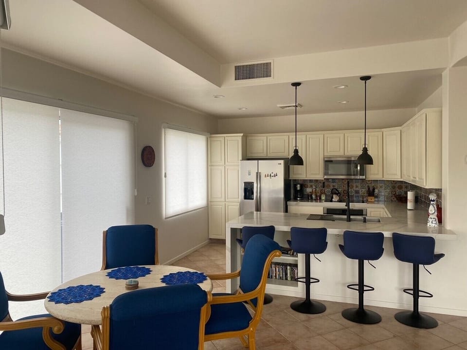 Upgraded kitchen with quartz countertop,  SS appliances, dining and bar areas