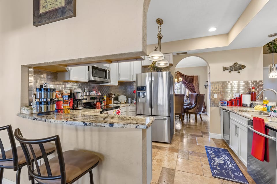 Second kitchen bar overlooks the pool