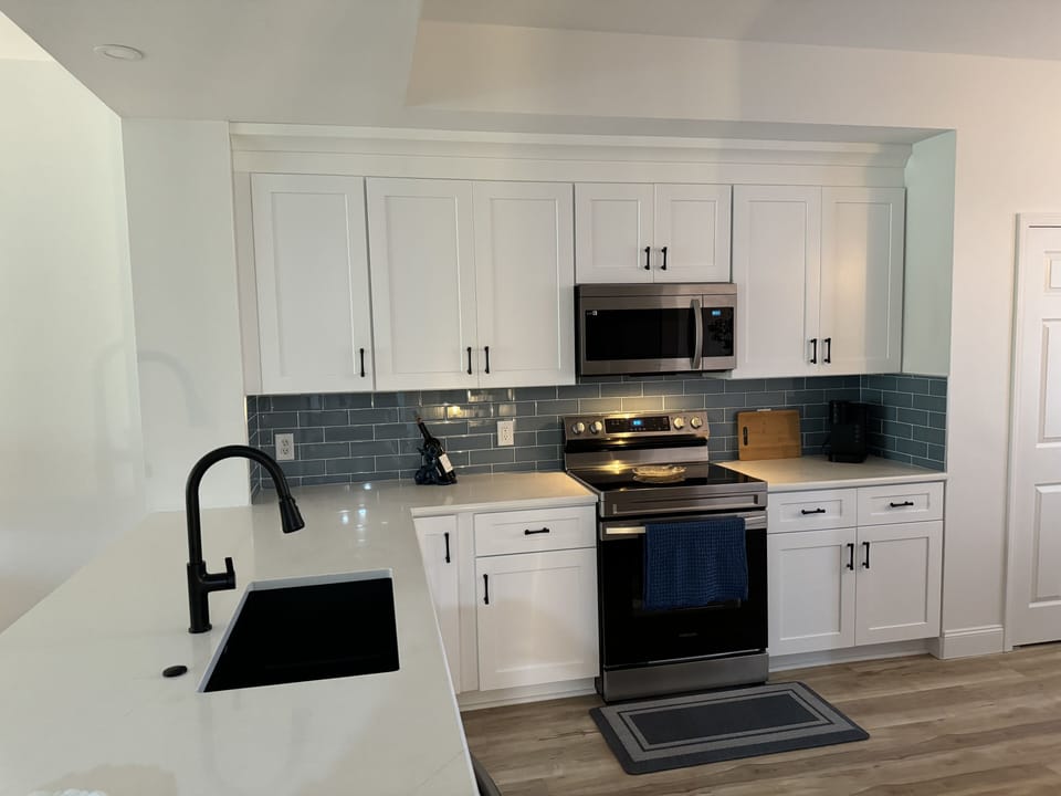Completely stocked high end kitchen; Quartz countertops with smart appliances