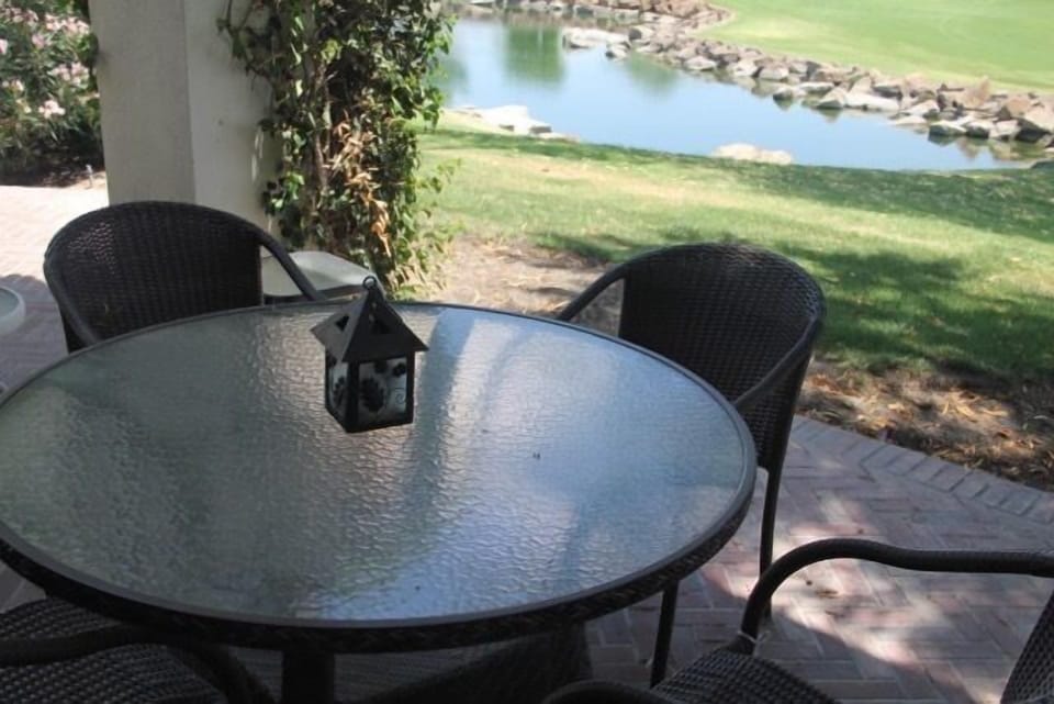 Outdoor dining table with golf course view.