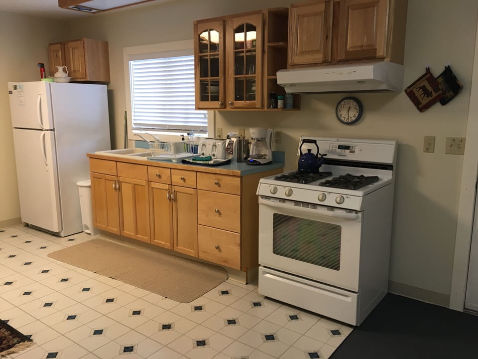 Kitchen with gas range, refrigerator, toaster, coffee maker and French press