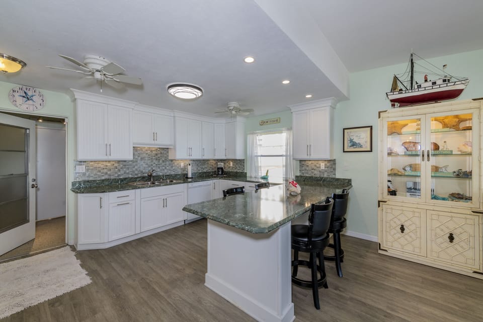 MODERN KITCHEN OPEN TO THE LIVING AREA   WITH VIEWS OF THE BEACH & OCEAN