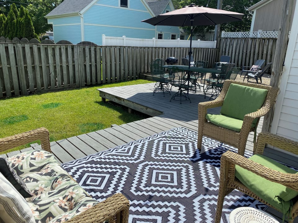 Backyard with seating area, umbrella table & chairs, charcoal grill, firepit