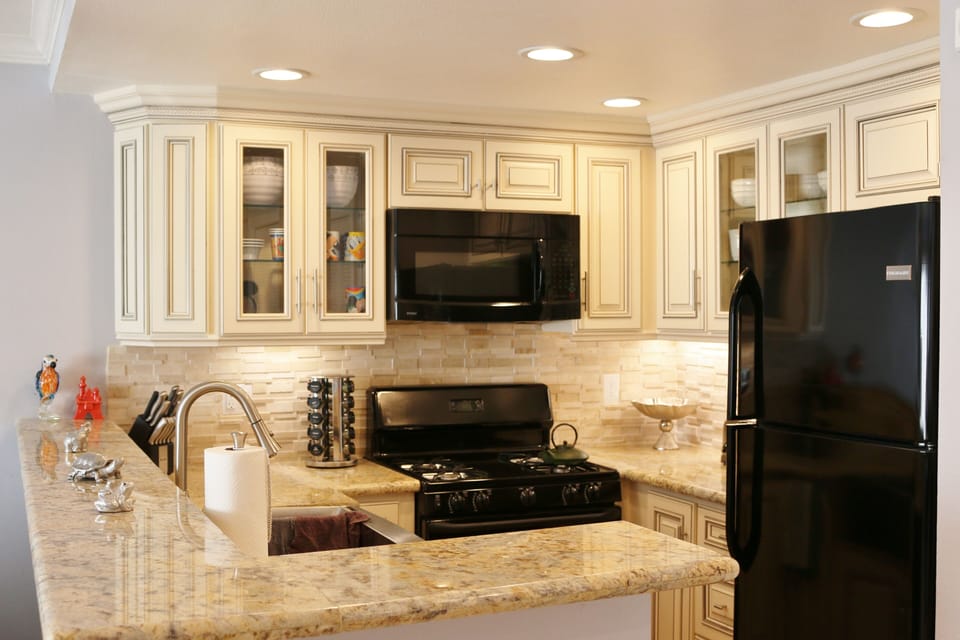 Remodeled Kitchen with New Granite Counter Tops and Appliances. Farm Style Sink.