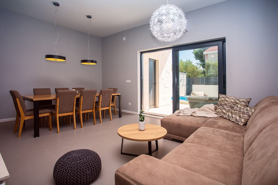 Dining area with 8 chairs, next to the living area with exit to the terrace