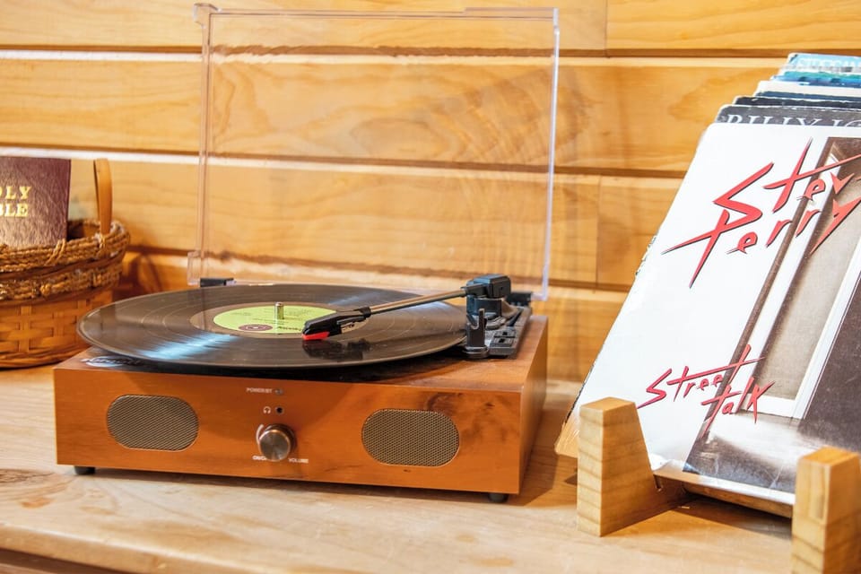 Spin your favorite vinyl records on this vintage turntable. A curated collection of albums and nostalgic touches create the perfect soundtrack for your getaway.