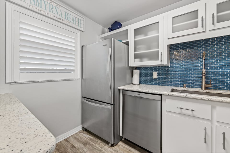 Prepare meals in style with newer stainless steel appliances in this modern, fully equipped kitchen.