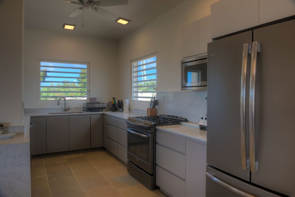 Kitchen with double-wide fridge, breakfast bar, lots of counterspace