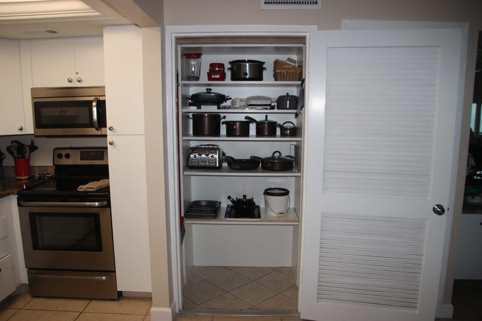 Kitchen cupboard has excellent assortment of cookware