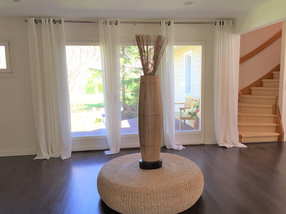 Open entry foyer with wall of windowed doors to Zen Garden