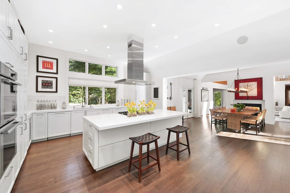 Thermador chefs kitchen with expansive island open to dining room & family room 