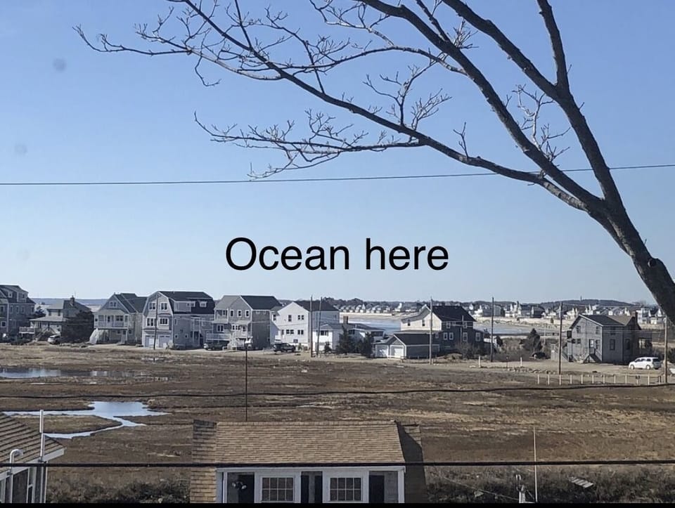 View off master bedroom deck. If you removed the houses you could see the ocean 