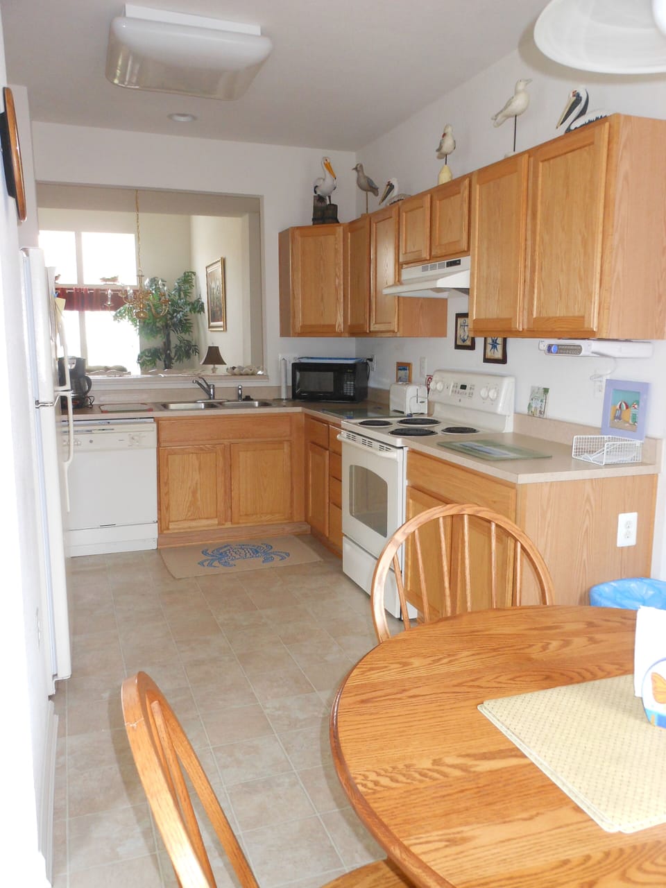 Eat in kitchen (seating for 4) stocked with necessities for cooking and eating.