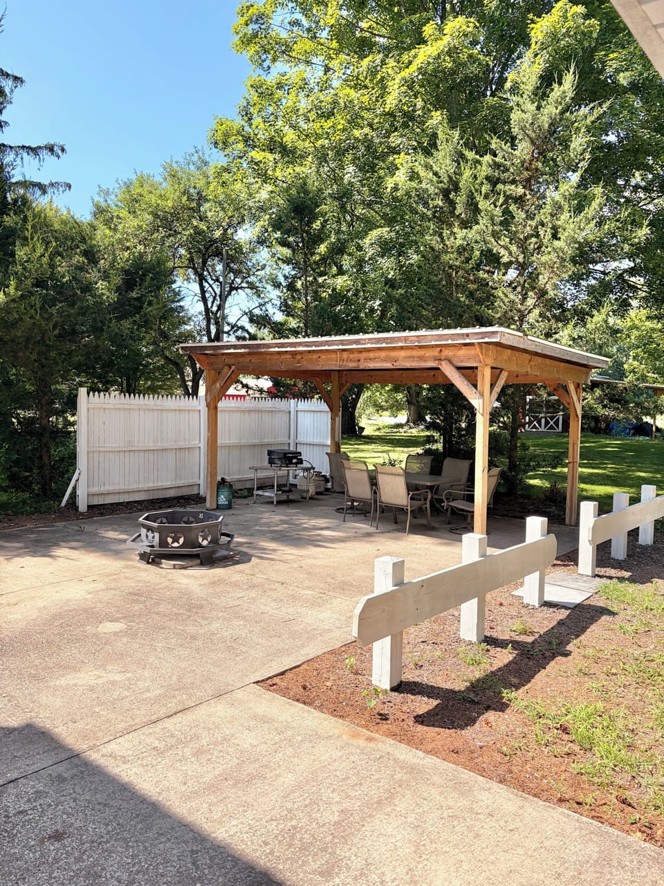 Covered patio area. Seats 6 with grill and fire pit.
