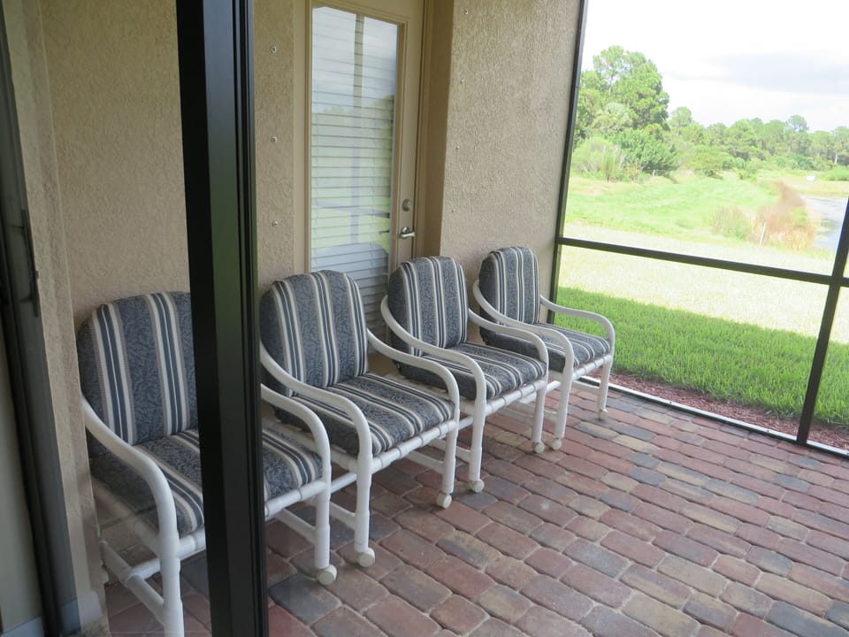 Patio Chairs with BBQ Over Looking a Pond