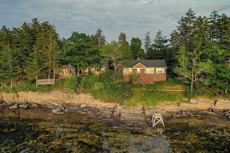 View of the cottage and the rocky shoreline, just steps away. 