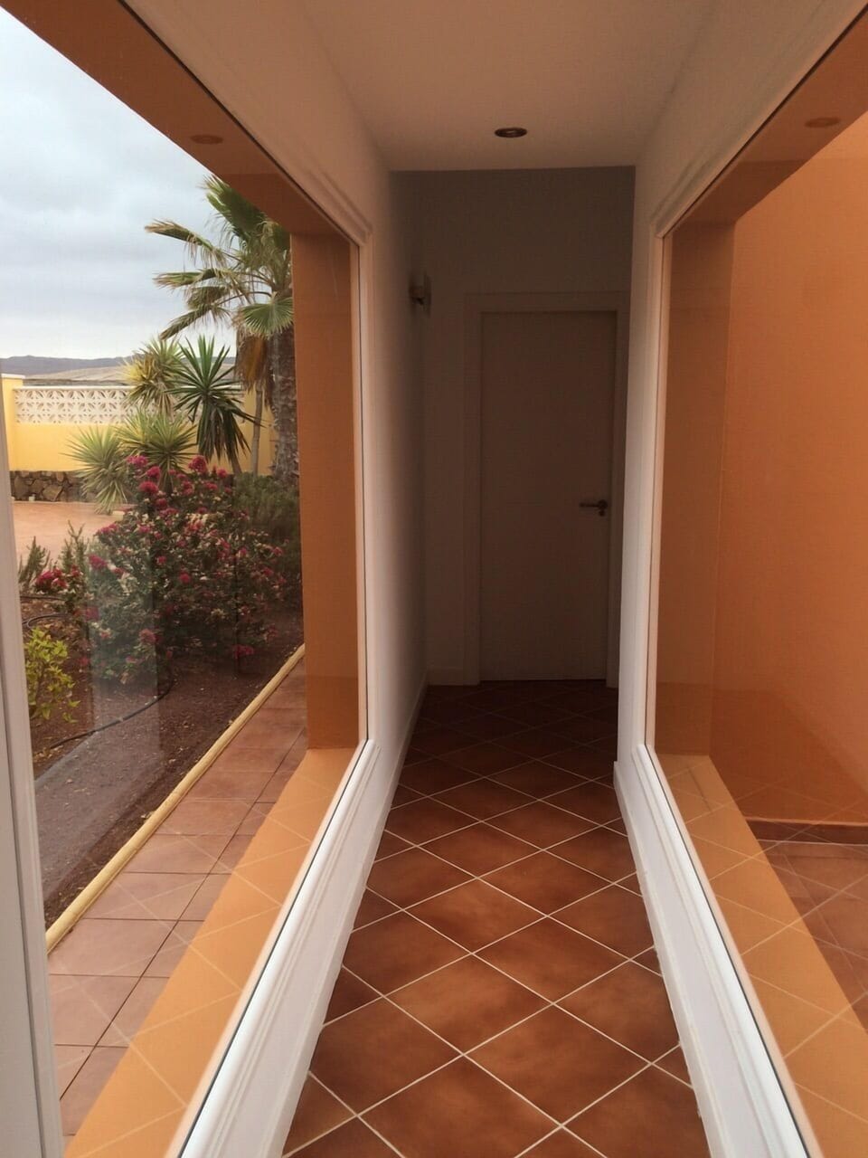 Glass corridor leading to Bedroom 2 with en-suite