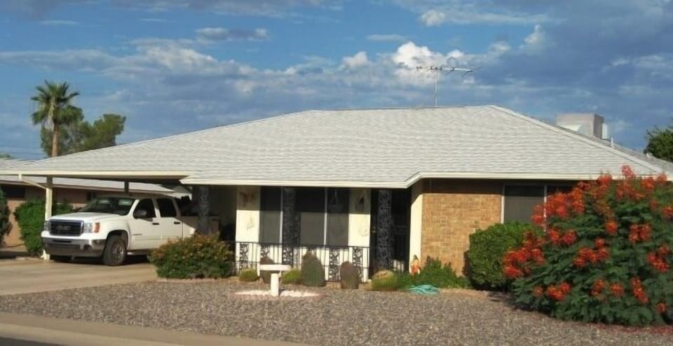 Spacious two-car covered carport allows for two vehicles to park comfortably.