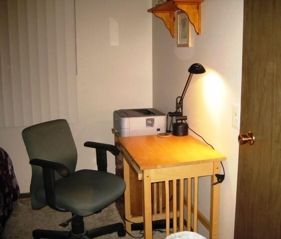 Second work area in guest bedroom includes printer access.