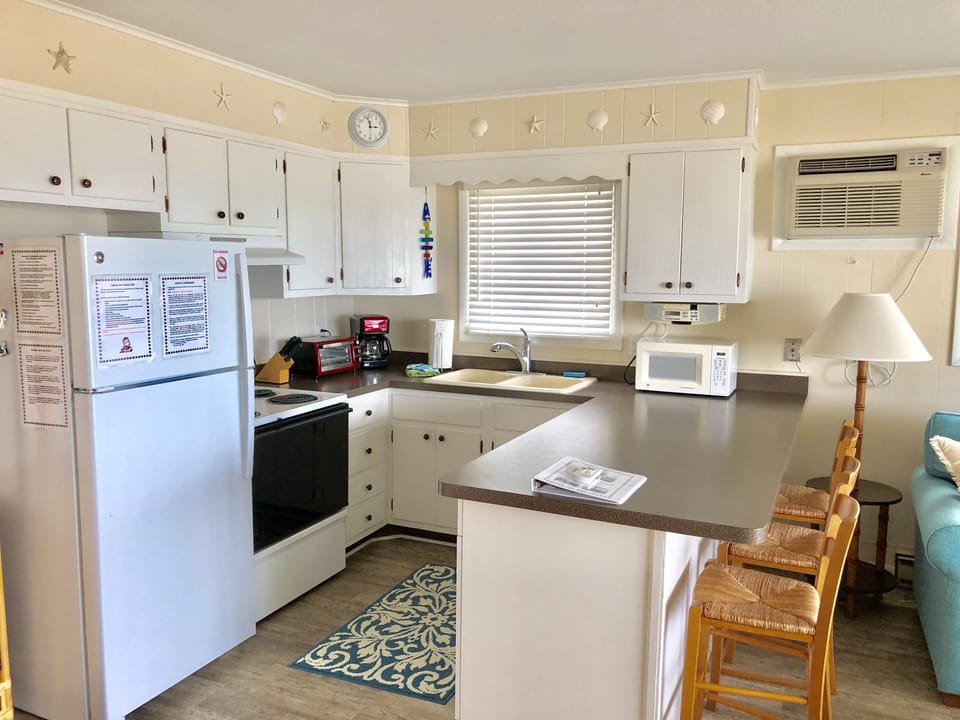 Fully stocked kitchen with breakfast bar seating