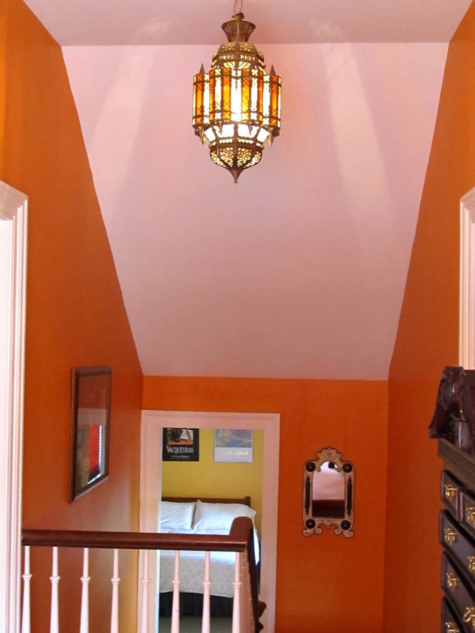 The upstairs hall with hand made Moroccan light. The Lake-view suite ahead.