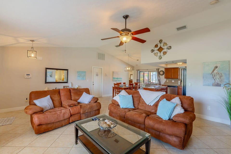The living room has comfortable seating, including recliners
