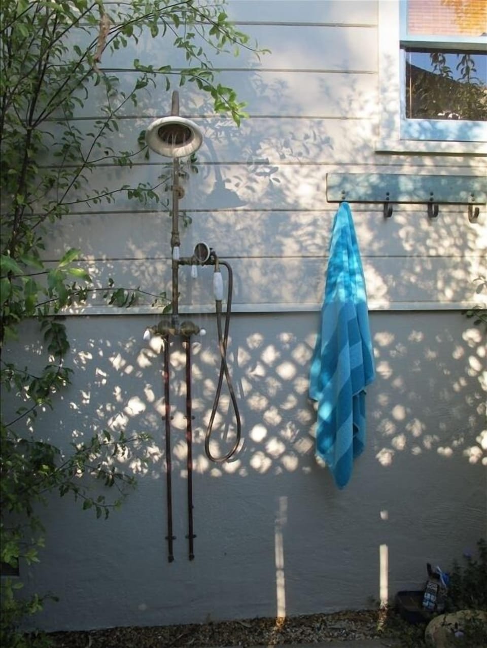 Outdoor, hot water shower w/hand spray for rinsing off the salt, sand & sun. 