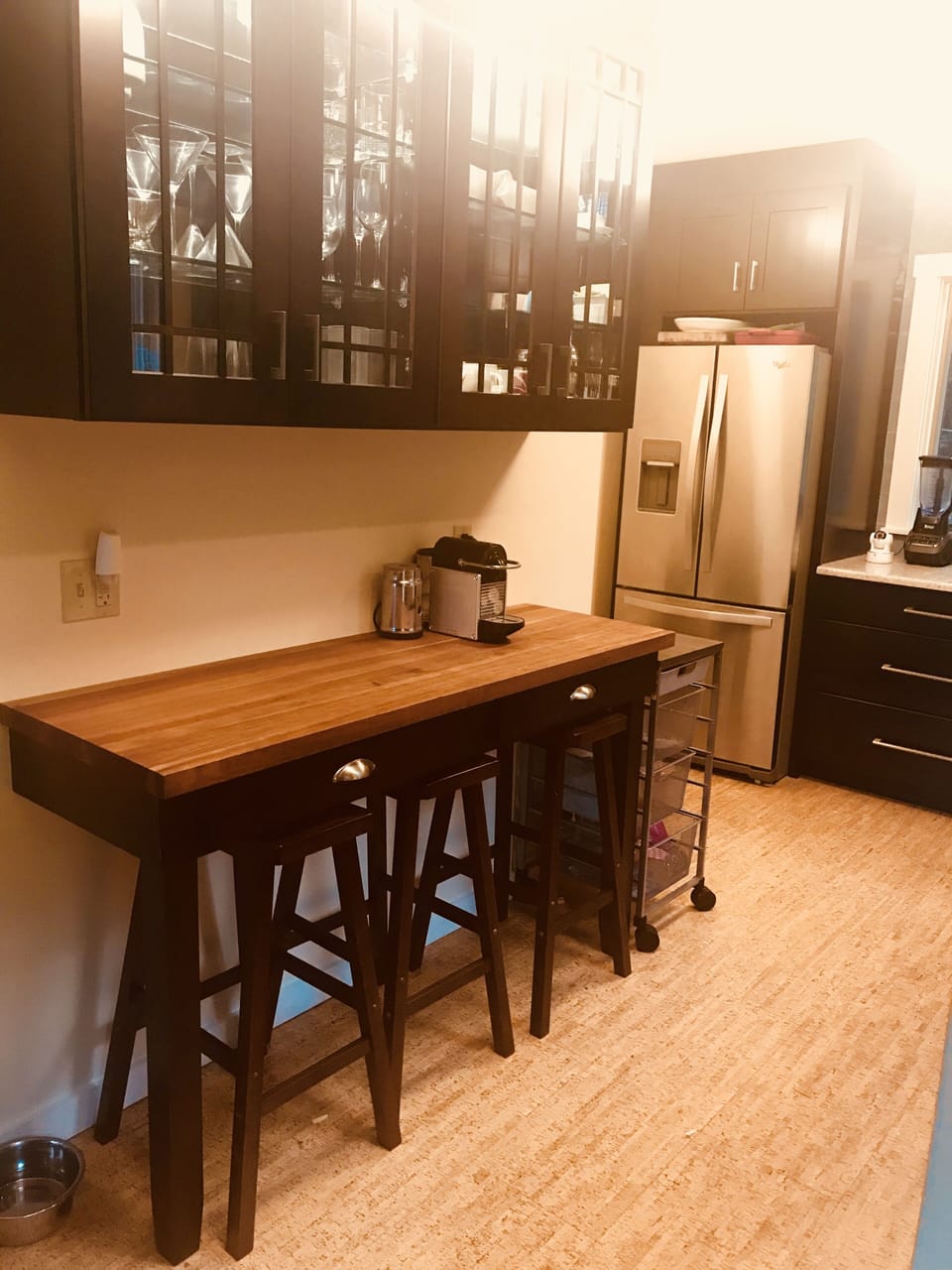 French door refrigerator and lighted glasses cabinet.
