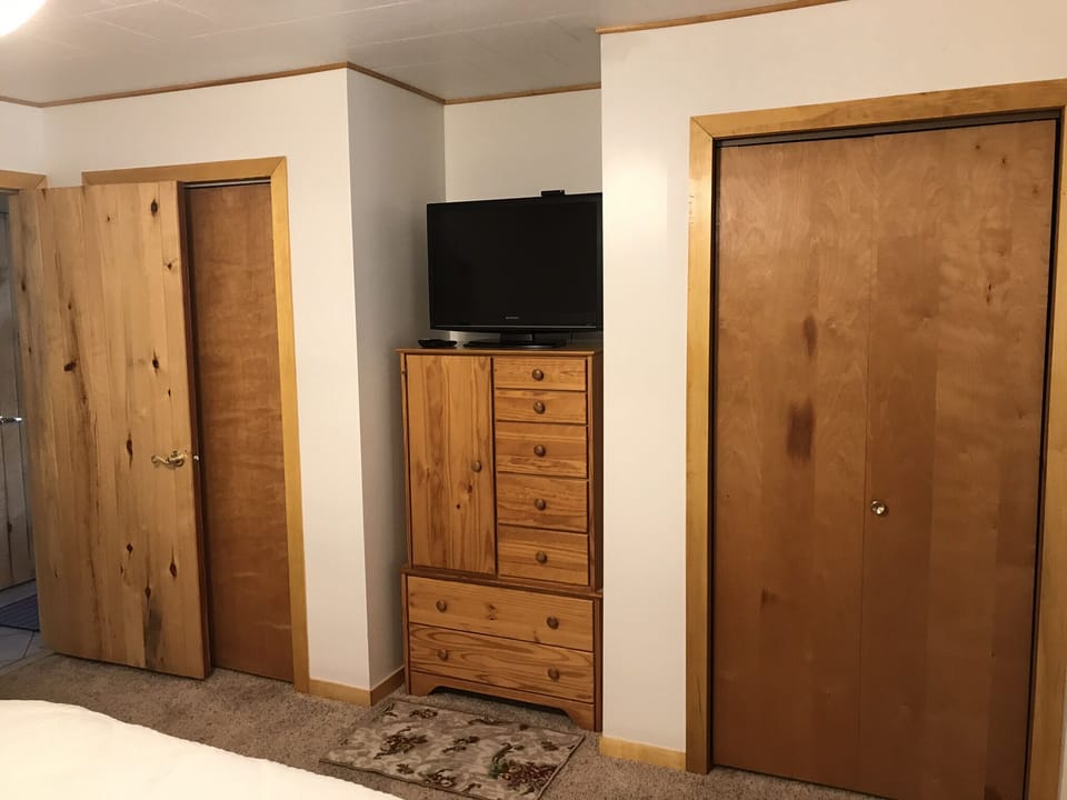 Main Floor Bedroom #1 closets & television.
