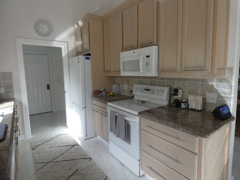 kitchen with refrigerator, stove, cooktop and microwave