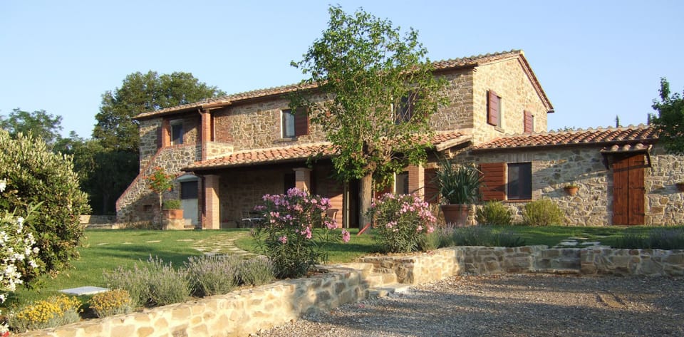 Front of house. With fields on all sides - no other houses are visible.