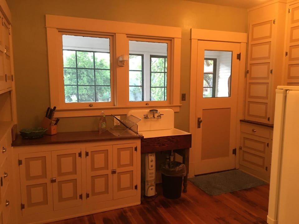 View from original kitchen sink to screened in porch 