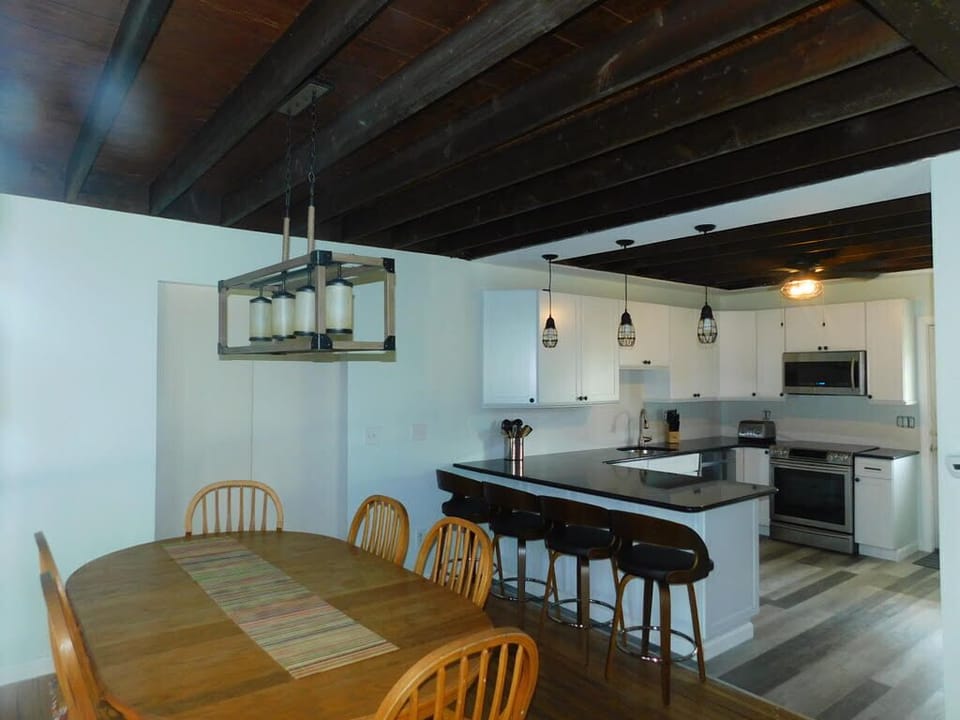 Open Dining - Bar Seating - Kitchen; with barn door slider to Bedroom / LR