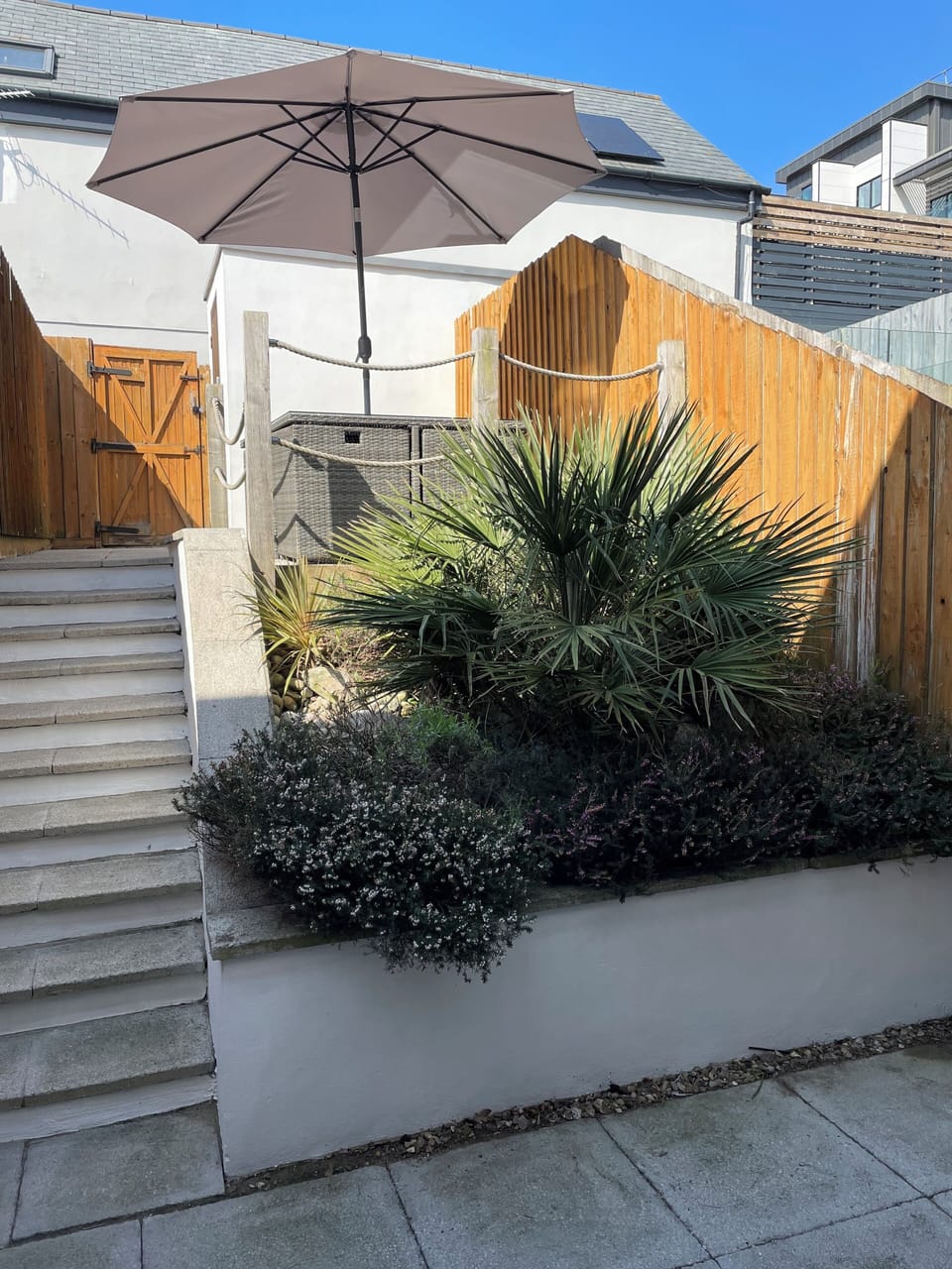 Private, enclosed rear garden with elevated seating/outdoor dining area