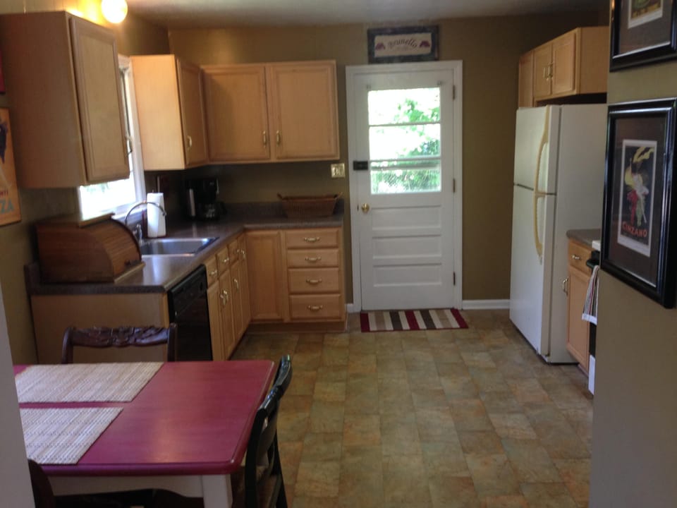 Kitchen has ample space for cooking and a table that seats 4